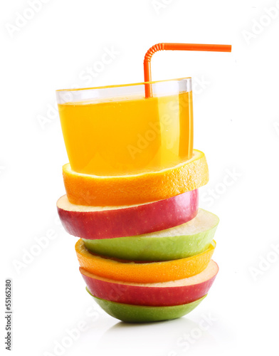 Stack of orange fruit and apples slices with juice.