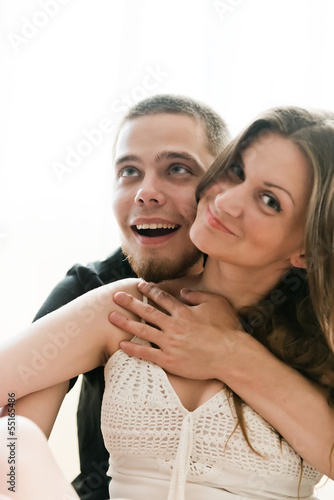 Portrait of a happy young couple having fun on the bed
