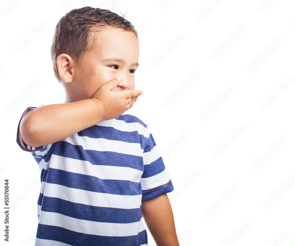 child covering his mouth on a white background child covering his mouth on a white background