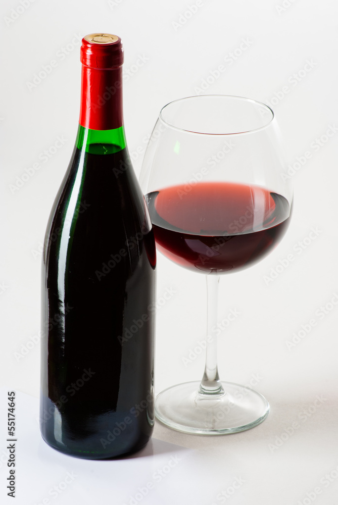 Wine bottle and a glass filled with wine isolated on white Wine bottle and a glass filled with wine isolated on white