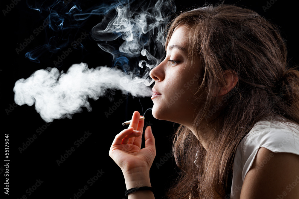 Woman Smoking a Cigarette on Black Background - obrazy, fototapety, plakaty 