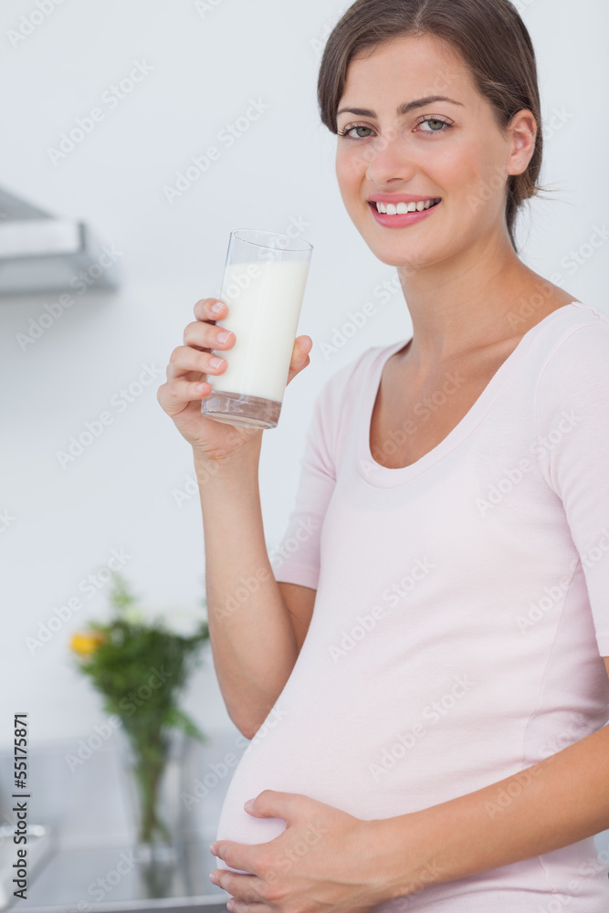 Pregnant woman drinking a glass of milk Pregnant woman drinking a glass of milk