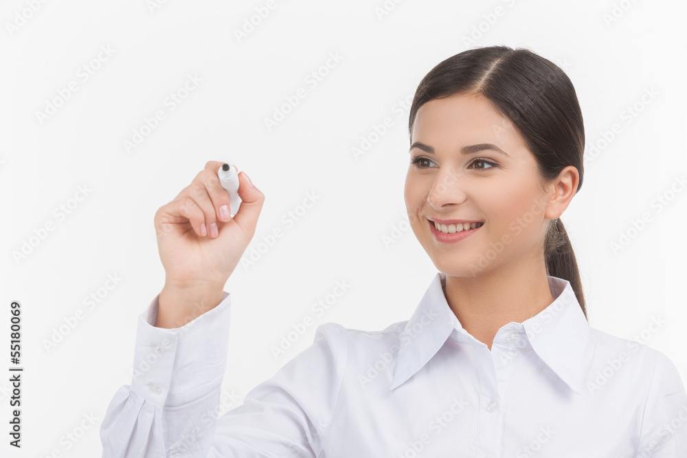 Writing on transparent wipe board. Beautiful young woman in whit Writing on transparent wipe board. Beautiful young woman in whit