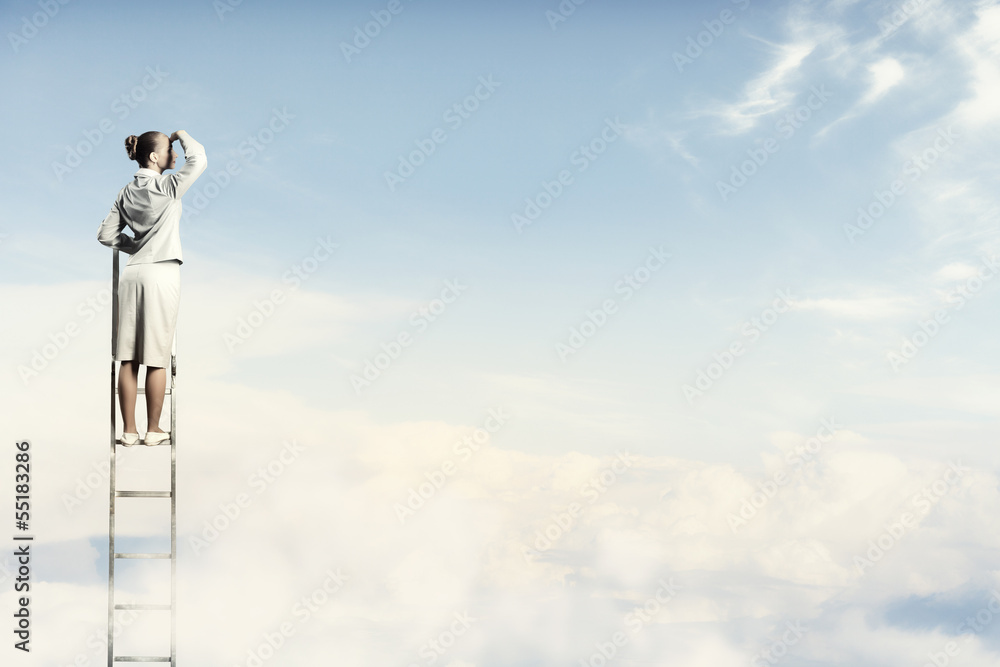 Businesswoman standing on ladder Businesswoman standing on ladder