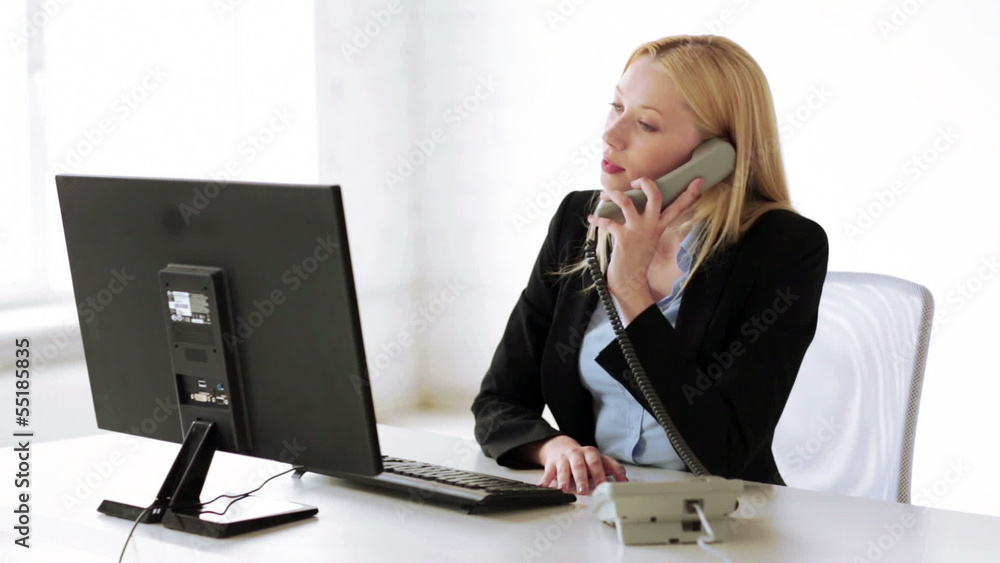 attractive office worker taking phone call attractive office worker taking phone call