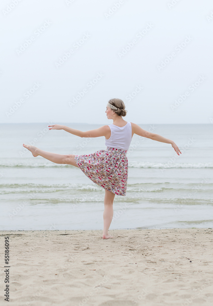 Young woman doing dancing elements near the sea Young woman doing dancing elements near the sea