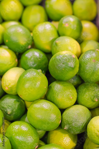 Lots of bright green limes in supermarket