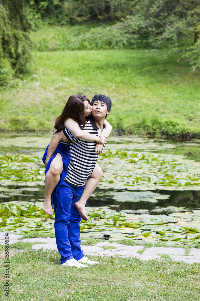 Fototapeta premium Lady Kissing her Lover in Front Pond