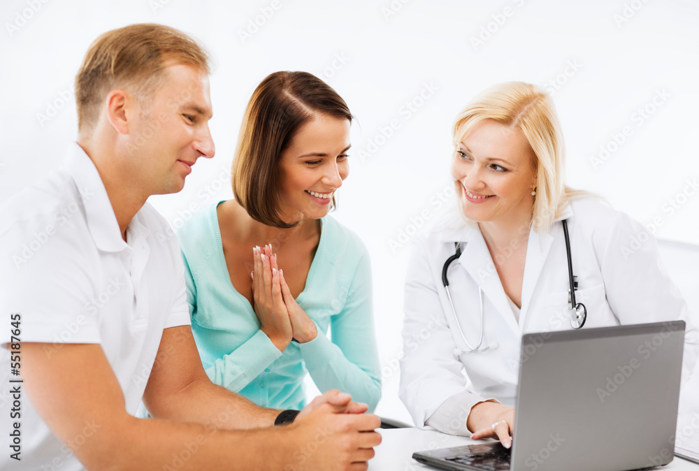 doctor with patients looking at laptop doctor with patients looking at laptop