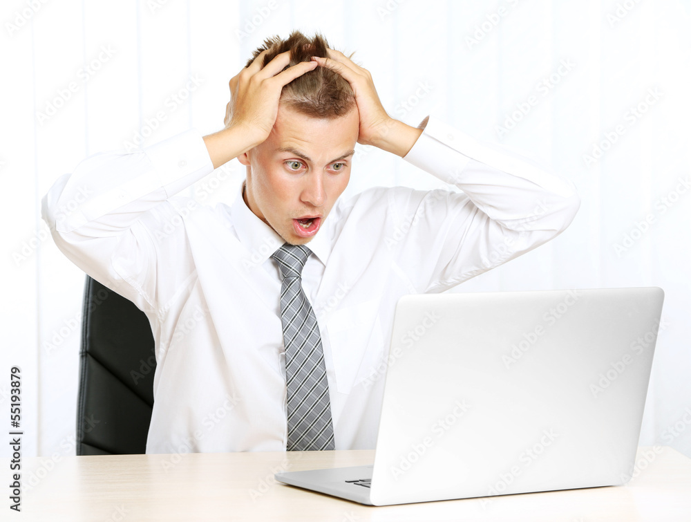 Portrait of young businessman working in office Portrait of young businessman working in office
