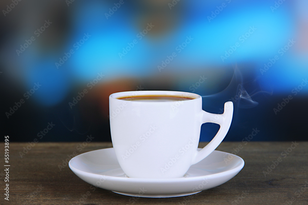 Cup of coffee on wooden table on bright background Cup of coffee on wooden table on bright background