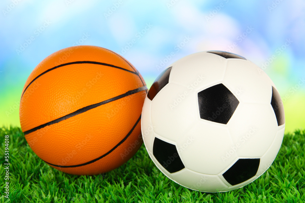 Sport balls, on green grass, on bright background