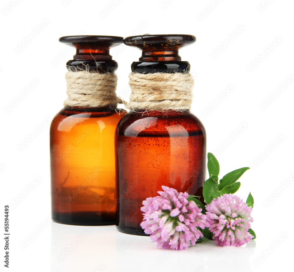 Medicine bottles with clover flowers, isolated on white Medicine bottles with clover flowers, isolated on white