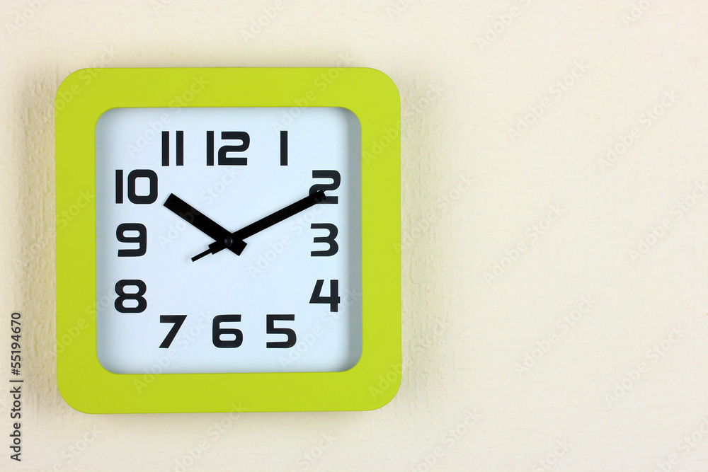 Office clock on color wall background Office clock on color wall background