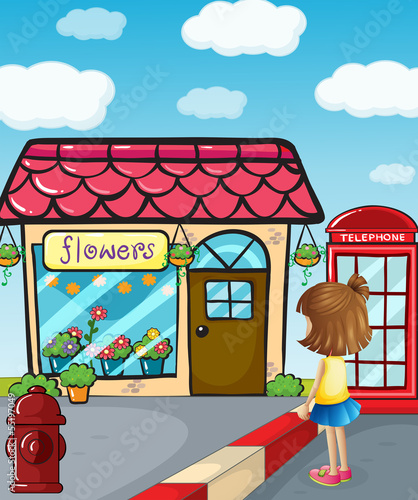 A small girl watching the flower shop