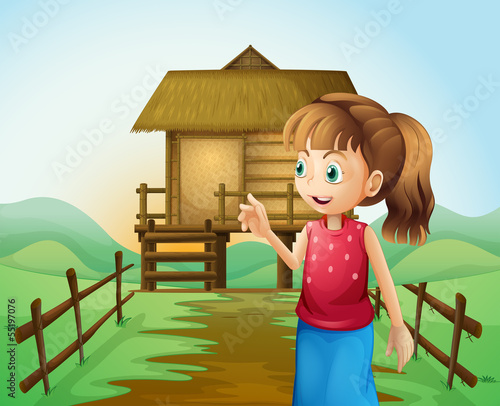 A woman in front of the nipa hut in the farm