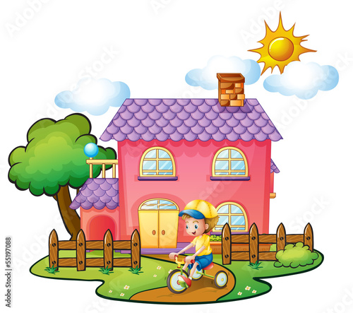 A little boy playing in front of their house