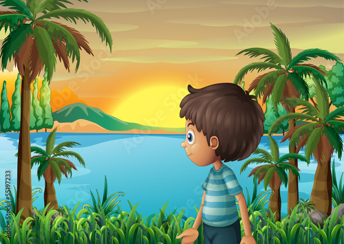 A riverbank with a young boy