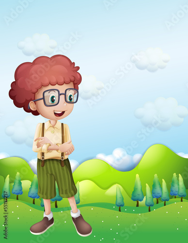 A boy standing across the hills