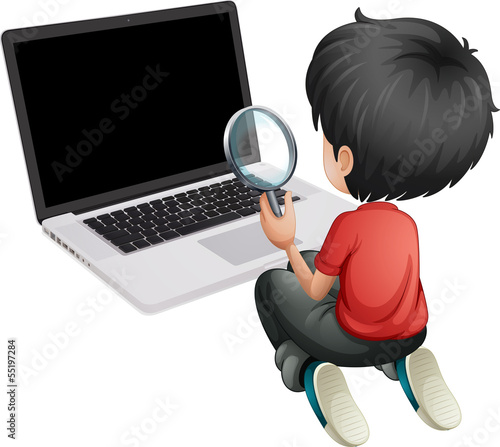 A boy in front of a laptop holding a magnifying lens