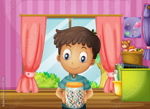A young boy holding a jar of candies