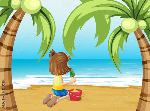 A beach with a young girl playing