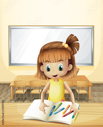 A girl inside the classroom with her books and crayons