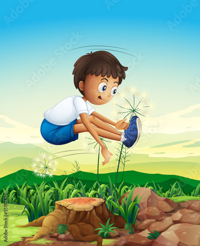 A boy jumping above the stump