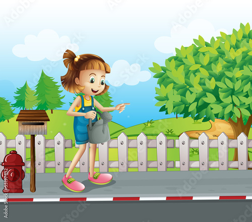 A girl walking in the street with a sprinkler