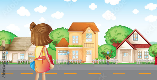 A girl with a bag across the neighborhood