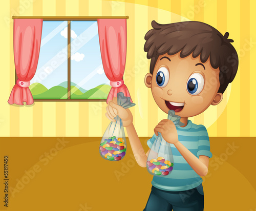 A boy holding two packs of bean candies