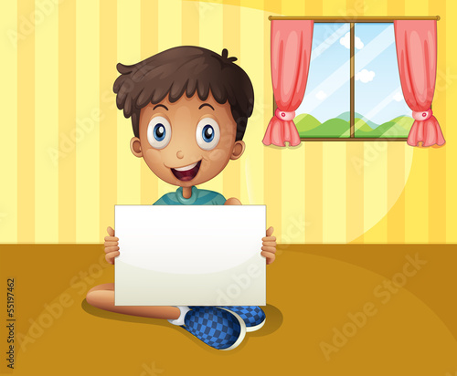 A boy sitting at the floor with an empty signboard