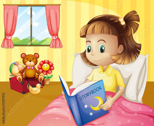A small girl reading a storybook inside her room