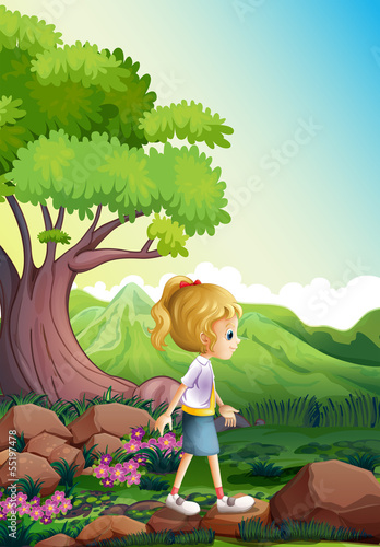 A girl walking above the rocks in the forest