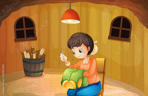 A woman sewing inside a wooden house