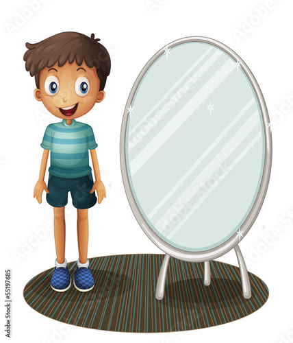 A boy standing beside the mirror