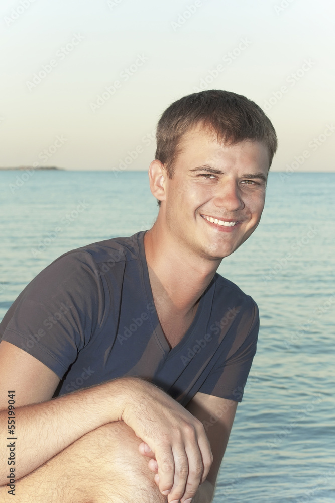 young guy on the background of the sea young guy on the background of the sea