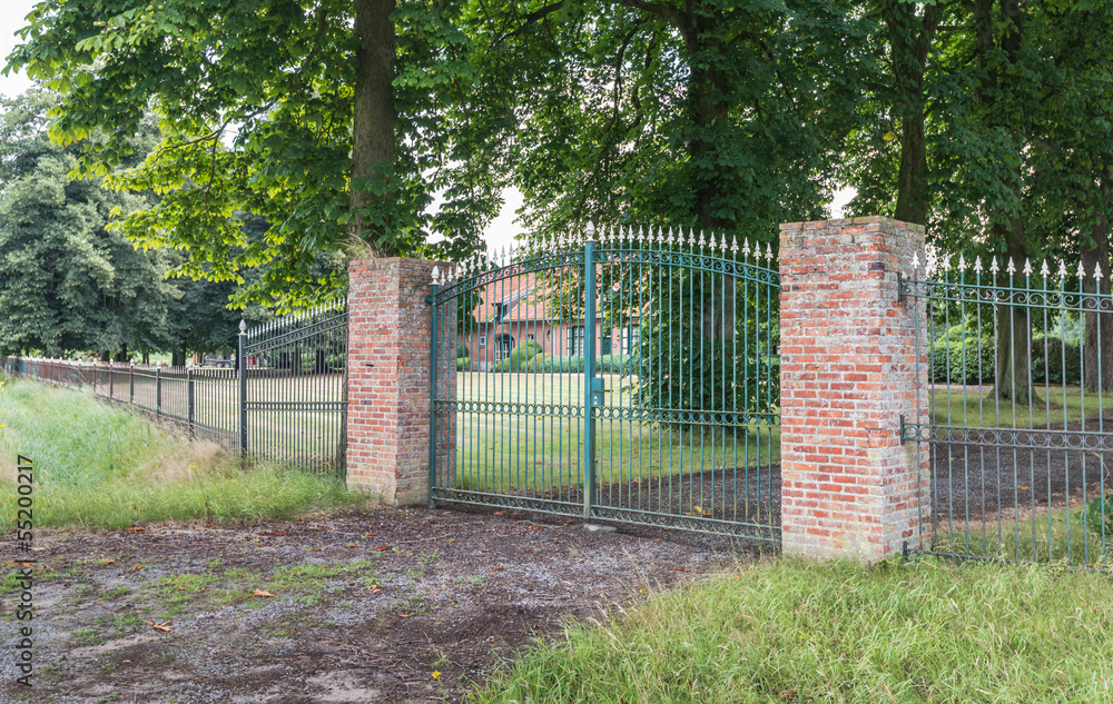 Green gate and two red pillars.