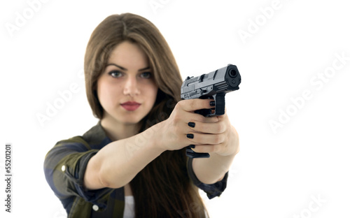 Young beautiful woman holding a gun on white background