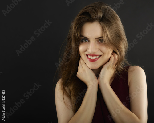 long hair young woman with dark makeup, studio black background