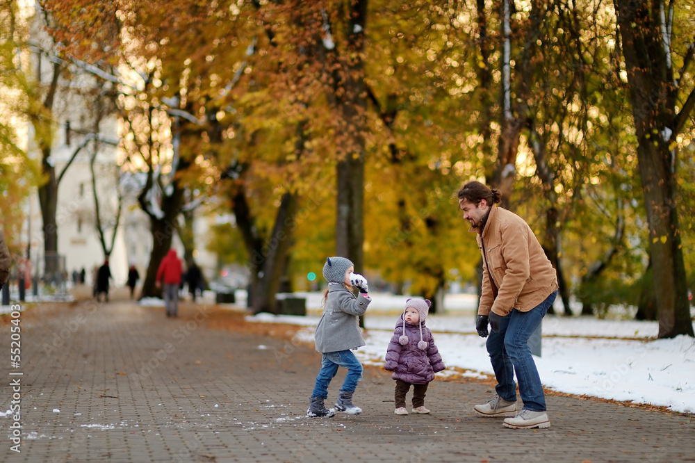 Fototapeta premium Father and two kids having fun on winter day