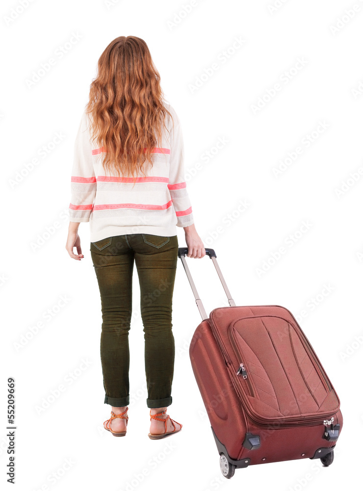back view of walking woman with suitcase. back view of walking woman with suitcase.