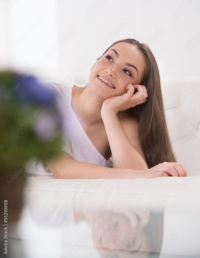 Woman dreaming. Beautiful young women sitting with her hand on c Woman dreaming. Beautiful young women sitting with her hand on c
