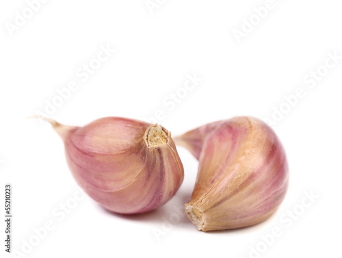 Red garlic cloves isolated on white