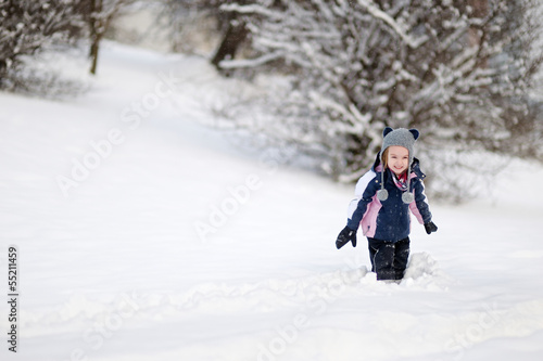Little girl having fun on winter day