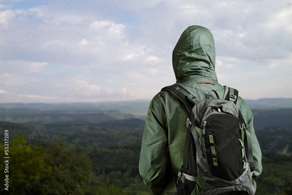 Hiker man enjoying view at nature with backpack.