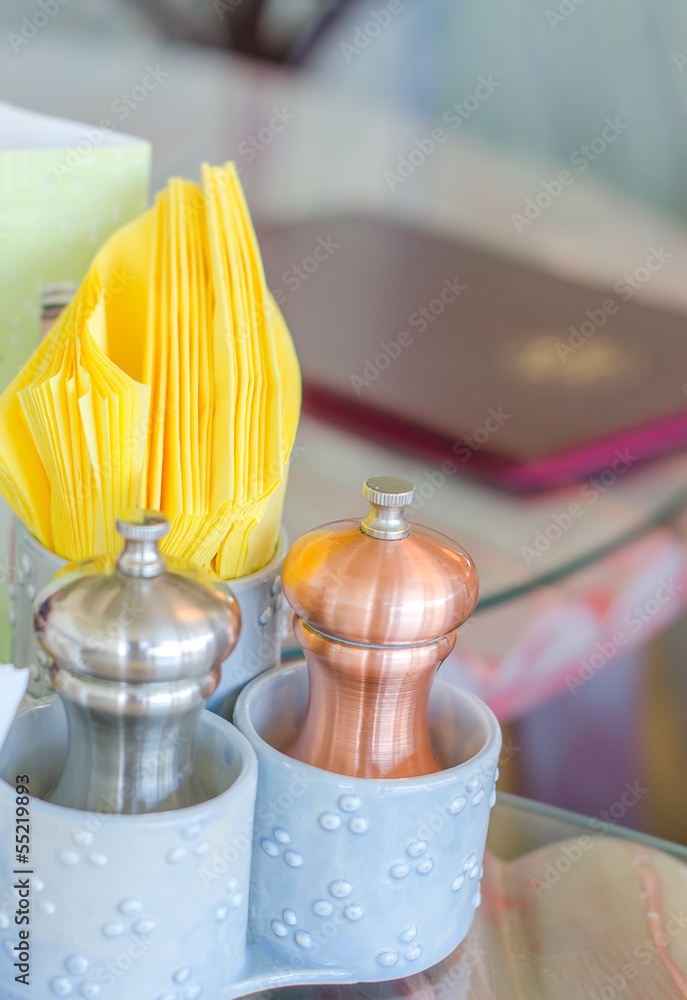 Closeup view of salt and pepper pots in cafe