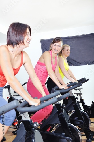 Beautiful women doing exercise in a spinning class at gym