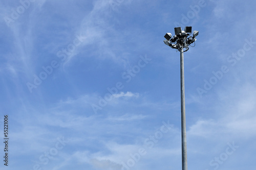 Spotlight pole isolated in blue sky