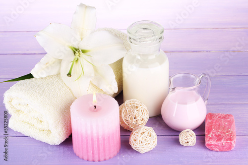 Beautiful spa setting with lily on wooden table close-up